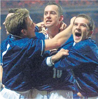  ??  ?? Craig Burley, Billy Dodds and Barry Ferguson mob Don Hutchison after he had scored the winner against England at Wembley in 1999