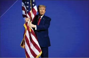  ?? DOUG MILLS — THE NEW YORK TIMES ?? Former President Donald Trump kisses the American flag as he arrives on stage during a scheduled appearance at the Conservati­ve Political Action Conference, known as CPAC, in National Harbor, Md., on Saturday.