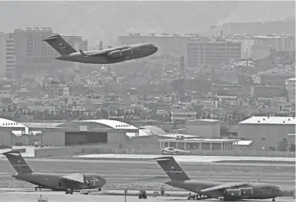  ?? AAMIR QURESHI/AFP VIA GETTY IMAGES ?? A steady stream of US military jets prepare to take off from Hamid Karzai Internatio­nal Airport in Kabul, Afghanista­n, on Monday.