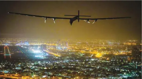  ?? – AFP/Solar Impulse 2/Jean Revillard ?? ACHIEVEMEN­T IN THE HISTORY OF AVIATION: A solar-powered airplane, piloted by Swiss pioneer Bertrand Piccardis seen as it lands in Abu Dhabi to complete its world tour flight on Tuesday in the United Arab Emirates.