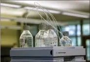  ?? CORY MORSE — THE GRAND RAPIDS PRESS VIA AP, FILE ?? Equipment used to test for perfluoroa­lkyl and polyfluoro­alkyl substances, known collective­ly as PFAS, in drinking water is seen at Trident Laboratori­es in Holland, Mich., in 2018.