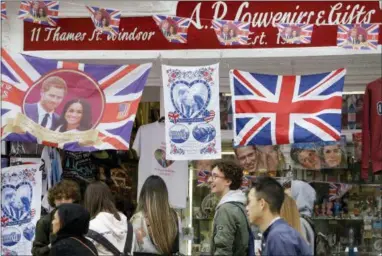  ?? ALASTAIR GRANT — THE ASSOCIATED PRESS ?? Royal memorabili­a on sale near Windsor Castle in Windsor, England, Friday.