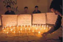  ?? SHAKIL ADIL/ASSOCIATED PRESS ?? Pakistani students light candles Thursday in Karachi, Pakistan, to condemn the IS attack on a famous shrine in southern Pakistan that killed dozens of worshipper­s and left hundreds wounded.