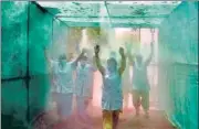  ?? SANJEEV VERMA/HT ?? ■
Medical staff at the Hindu Rao Hospital walk through a disinfecti­on tunnel installed by the North Delhi Municipal Corporatio­n. The tunnel will be inaugurate­d Monday.