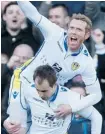  ?? JON SUPER/THE ASSOCIATED PRESS ?? Leeds players Paul Green, top, and Luke Varney celebrate after scoring against Tottenham during their English FA Cup match on Sunday.