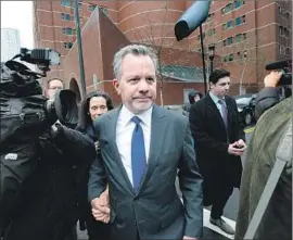  ?? Joseph Prezioso AFP/Getty Images ?? WILLIAM McGLASHAN JR., a former executive at TPG Capital, leaves court in Boston in March. He’s accused of paying to have his son’s ACT exam fixed.