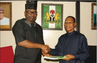  ??  ?? L-R: Chairman, House of Representa­tives Committee on Aids, Loans and Debt Management, Hon. Adeyinka Ajayi. in a warm handshake with the Director-General, Debt management Office, Dr Abraham Nwankwo, when the Ajayi led members of the committee of a...