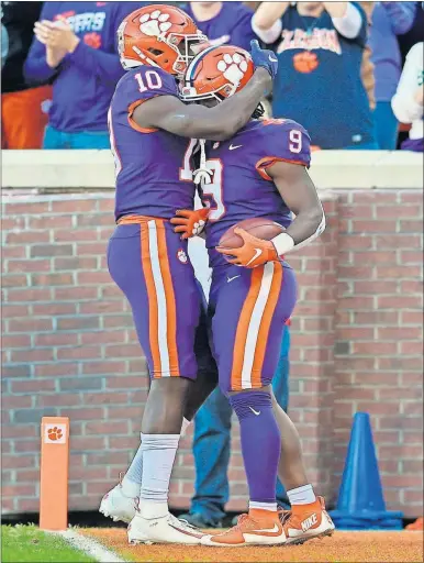  ?? [THE ASSOCIATED PRESS] ?? Clemson’s Joseph Ngata, left, celebrates Travis Etienne’s touchdown during last Saturday’s game against Wofford in Clemson, S.C. The unbeaten Tigers are ranked fifth in the CFP rankings.