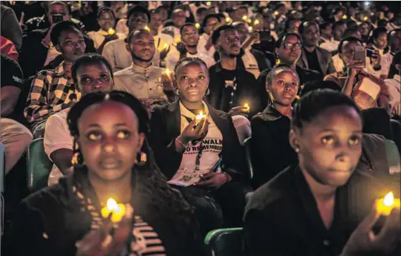  ?? Photo: Luis TATO/AFP ?? Shine a little light: Young Rwandans hold candles during a vigil at the 30th anniversay commemorat­ion of the 1994 Rwandan genocide.