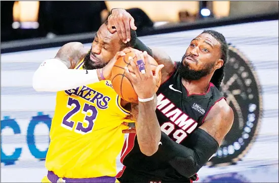  ??  ?? Los Angeles Lakers forward LeBron James and Miami Heat forward Jae Crowder battle for a rebound during the second half in Game 4 of basketball’s NBA Finals on Oct 6, in Lake Buena Vista, Fla. (AP)