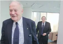  ?? JOHN MAHONEY/FILES ?? Roy Heenan, left, and Donald Johnston, who founded the Heenan Blaikie law firm, walk past packing boxes following the announceme­nt that the firm was closing in February 2014.