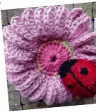  ??  ?? Spot the mini beast! This felted ladybird sits on a knitted flower