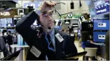  ?? RICHARD DREW — THE ASSOCIATED PRESS ?? Trader Gregory Rowe works on the floor of the New York Stock Exchange, Tuesday. Stocks are opening broadly higher on Wall Street as stocks add to the records they’ve set in the last few days.