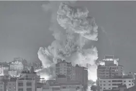  ?? AGENCE FRANCE PRESSE ?? Fire and smoke rise above buildings in Gaza City during an Israeli air strike on October 8, 2023.