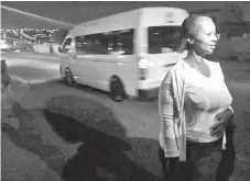  ??  ?? Zanele Thusi, a domestic worker, walking in the street with the patrollers en route to work in Johannesbu­rg.