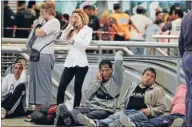  ??  ?? Distressed: Commuters react in shock inside the Once train station..