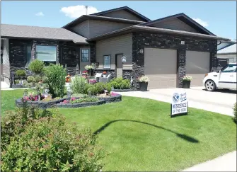  ?? SUBMITTED PHOTO JAN OWEN ?? Best Residence for Zone 1 is located at 82 Huxley Place N.E., owned by George and Tammy Leith. Judges said this residence is immaculate with a mix of shrubs, flower beds, potted plants and an eye catching feature flower bed.