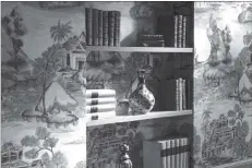  ?? CHRISTOPHE BIELSA ?? Period style wallpaper continues behind the shelves to liven displays of books and antiques.