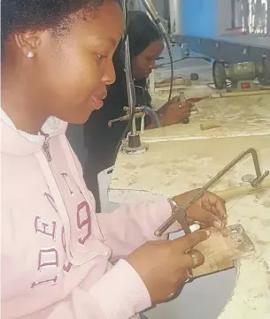  ??  ?? BRIGHTENIN­G UP THE FUTURE: Graduate jewellery designer Nhlanhla Mahlangu hard at work designing a wedding ring