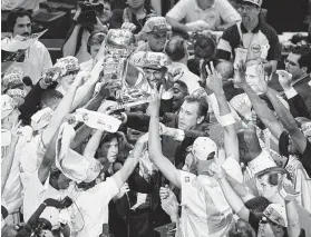  ?? Pat Sullivan / Associated Press ?? The Rockets won NBA titles in 1994 and 1995 under Rudy Tomjanovic­h, center, surrounded by his players after beating the Magic for their second crown.