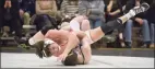  ?? H John Voorhees III / Hearst Connecticu­t Media ?? Trumbull’s Matt Ryan, in black, and Danbury’s Logan Kovacs, in white, wrestle in the 138-pound weight class during a match in 2019.