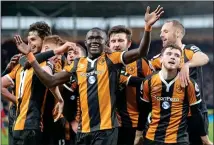  ??  ?? STAYING UP: Hull can believe as Oumar Niasse leads the celebratio­ns after his goal clinched the win over Liverpool