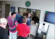  ?? ASSOCIATED PRESS FILE PHOTO ?? In this July 31, 2015, file photo, people line up to be among the first in Nevada to legally purchase medical marijuana at the Silver State Relief dispensary in Sparks, Nev.