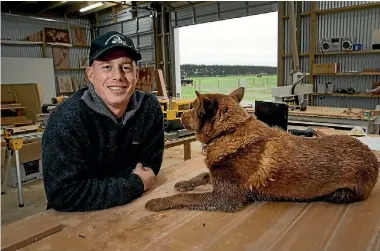  ?? PHOTO: WARWICK SMITH/STUFF ?? Stu Bradbury in his workshop with his dog Clay.