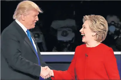  ??  ?? STILL ABLE TO LAUGH: Donald Trump and Hillary Clinton shake hands at the end of the 97-minute debate at Hofstra University, New York.