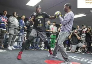  ??  ?? WISE HEAD: Breland takes Wilder on the pads as they prepare to defend the WBC heavyweigh­t title