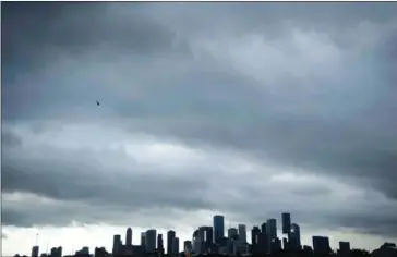  ?? BRENDAN SMIALOWSKI/AFP ?? A view of the Houston skyline after heavy rains broke during the aftermath of Hurricane Harvey on Tuesday.