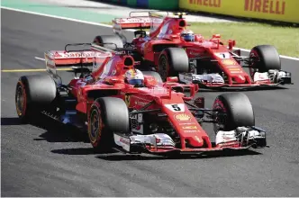 ??  ?? BUDAPEST: Ferrari’s German driver Sebastian Vettel (L) and Ferrari’s Finnish driver Kimi Raikkonen take part in the qualifying at the Hungarorin­g racing circuit in Budapest yesterday prior to the Formula One Hungarian Grand Prix. —AFP