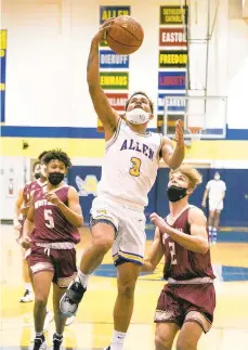  ?? DOUG KILPATRICK / THE MORNING CALL ?? Allen’s Manny Ozuna goes in for a layup as Whitehall’s Tommy Buskirk (2) and Ian Werner give chase Saturday afternoon at Allen’s Sewards Gym. Ozuna scored 15 points on 6-for-9 shooting as the Canaries pulled away to a 64-41 victory.