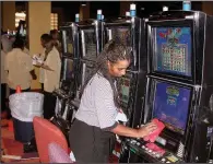  ?? Democrat-Gazette file photo ?? Southland Casino Racing employee Ollie Dyson polishes a betting machine Nov. 8, 2006, just before the West Memphis racetrack opened its casino to the public for the first time.