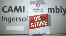  ?? Reuters-Yonhap ?? A strike poster from the auto workers union Unifor is posted at a picket line outside the General Motors CAMI assembly plant in Ingersoll, Ontario, Canada, Friday.