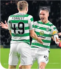  ??  ?? Mikel Lustig congratula­tes James Forrest on scoring