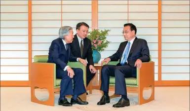  ?? AFP ?? Premier Li Keqiang engages in conversati­on on Thursday with Japan’s Emperor Akihito (left) at the Imperial Palace in Tokyo. He said he hoped bilateral ties improve. It was the first time a Chinese premier has met with the emperor since June 2010....