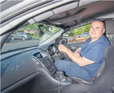  ?? ?? Stephen behind the wheel of his ‘reasonably priced star car’