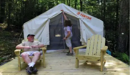  ?? AMY SHORTELL — THE MORNING CALL VIA ASSOCIATED PRESS ?? This July 13, 2018 photo shows Scott and Christina Dietrich in Jim Thorpe, Pa. The couple decided to make good on a 40-year dream and find a secluded property of their own. For $170 a night through an online service called Tentrr, the Dietrichs in May began renting out the campsite to a new kind of camper. Tentrr is the Airbnb or Uber of the great outdoors.