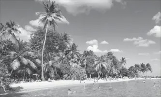  ?? MAURA JUDKIS WASHINGTON POST ?? Beachgoers splash along the shore on Plage de la Caravelle, near the city of Sainte-Anne on Grande-Terre, one of several islands in Guadeloupe.