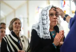  ?? WATCHARA PHOMICINDA — STAFF PHOTOGRAPH­ER ?? Maria Torres, of Perris, receives ashes from Rev. Ephraim Arciga during an Ash Wednesday service at St. Catherine of Alexandria Catholic Church in Riverside on Wednesday.