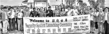  ??  ?? Tiong (ninth right, front row) and others giving a thumbs up after the launching ceremony of Pulau Li Hua security system.