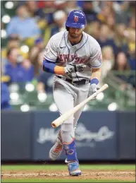  ?? John Fisher / Getty Images ?? The Mets’ Jeff McNeil throws his bat after flying out in the seventh inning against the Milwaukee Brewers on Saturday.