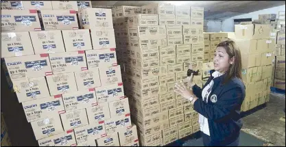  ?? EDD GUMBAN ?? Manila Department of Social Welfare officer Lindsay Kaye Javier shows boxes of goods ready for repacking at the Manila Youth Reception Center in Arroceros, Manila yesterday. The relief goods are being readied in case evacuation sites need food packs and blankets during Typhoon Betty.