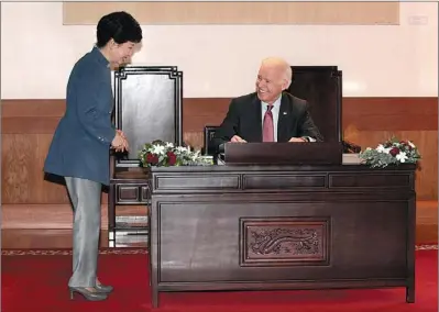  ?? AHN YOUNG-JOON / REUTERS ?? Park Geun-hye, president of the Republic of Korea, talks with US Vice-President Joe Biden as he signs the guest book upon his arrival for their meeting at the presidenti­al Blue House in Seoul on Friday.