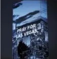  ?? JOHN LOCHER — THE ASSOCIATED PRESS JAKE MAY — THE FLINT JOURNALMLI­VE.COM VIA AP ?? The marquee at the W Hotel shows a sign for the victims of a mass shooting on Wednesday in Las Vegas. Stephen Paddock opened fire on an outdoor music concert on Sunday killing dozens and injuring hundreds. Alyssia Washington, 24, of Flint, Mich., gasps...