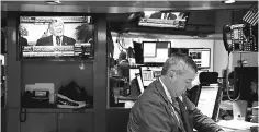  ?? — AFP photo ?? President Donald Trump is displayed on a television screen as traders and financial profession­als work on the floor of the New York Stock Exchange (NYSE) ahead of the closing bell, August 2, in New York City. The blue chip Dow Jones Industrial Average...