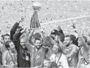 ?? James Nielsen / Houston Chronicle file ?? Former Dynamo Wade Barrett hoists the trophy after the Orange beat the Revolution in 2007, the last time the Dynamo reigned over Major League Soccer.