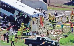  ??  ?? First responders work at the scene of a bus-truck crash on Interstate 40 in New Mexico in this image from video provided by KQRENews13.