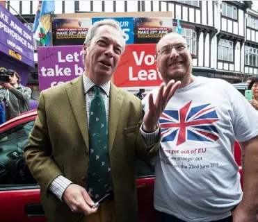  ??  ?? UKIP leader Nigel Farage stands with a Brexit supporter during his party’s referendum ‘Brexit Battle Bus Tour’. Photo: Lauren Hurley/PA